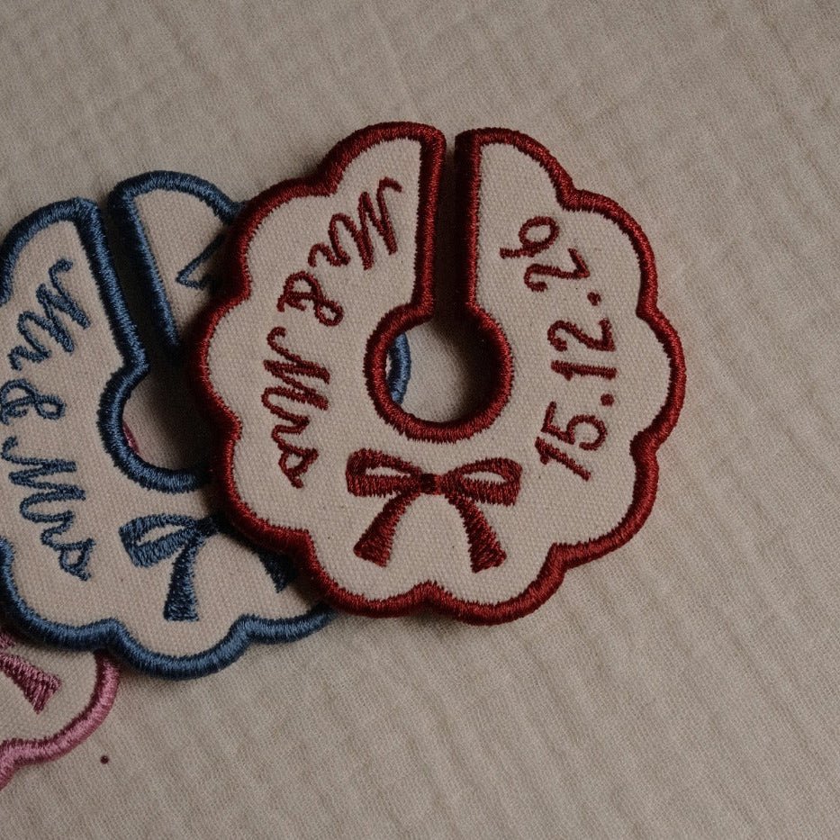 Set of personalised embroidered wedding wine stem tags in blue and burgundy