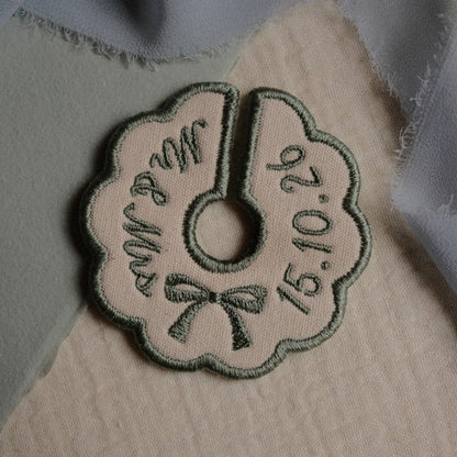 Sage green embroidered wine stem tag with personalised wedding details