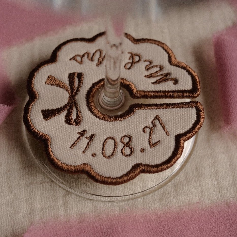 Beige personalised embroidered wine charm with bow detail and custom dat