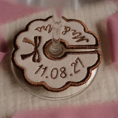 Beige personalised embroidered wine charm with bow detail and custom dat