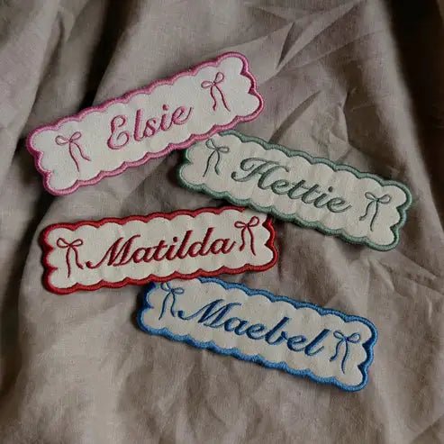 Four bookmarks, custom embroidered with names.