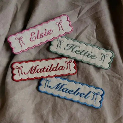 Four bookmarks, custom embroidered with names.